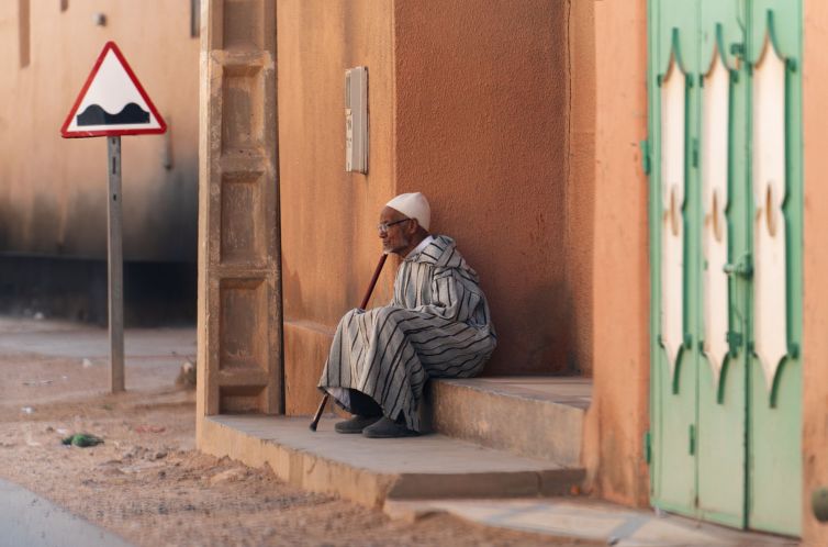 Old-man-at-house-entrance